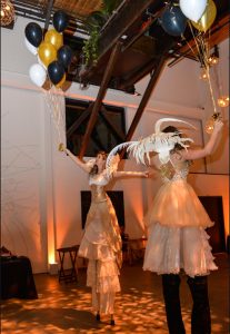 Cream and Gold Stiltwalker Duo Holding Balloons