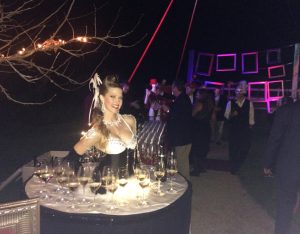 Fabulous burlesque showgirl Living Table greeting & serving wine at Napa Gras- JCB wine industry event at Raymond Vineyards-www.catalystarts.com
