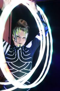 Body Painted Model Holding Light Up Hoops