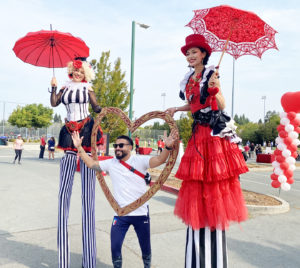 Circus Stilt Walkers at Heart Walk with big love heart frame by Catalyst Arts