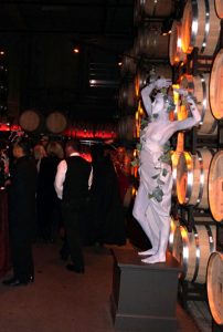 Living Statue Standing in front of wine barrels