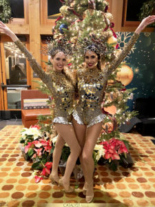 Two Mirror Showgirls standing infront of a Christmas Tree