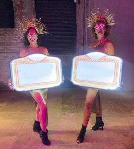 Gold Showgirls with signs