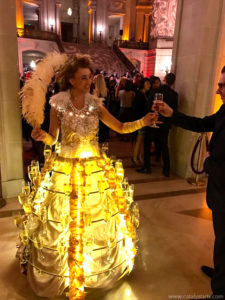 Golden Light Champagne Skirt Showgirl Handing out champagne to guests
