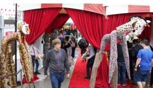 Giraffe and Tiger Party Animals Stilt Walkers walking along the red carpet on a circus theme setting