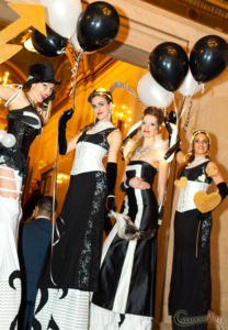 Four Black and White Stiltwalkers