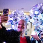 woman taking a selfie with two mirror dancers