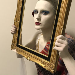 Colored Porcelein Statue Holding a vintage photo frame