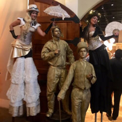 Golden Living Statue duo in between two steampunk stiltwalkers
