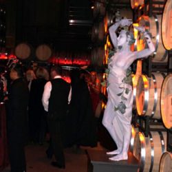 Living Statue Standing in front of wine barrels