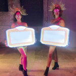 Gold Showgirls with signs
