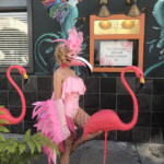 Flamingo Costumed Performer in line with Flamingo Statues