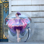 Ballerina wearing a butterfly costume inside a bubble